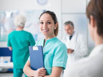 Young female medical student working at the hospital and medical staff, she is holding medical records; Shutterstock ID 1029028150; PO: ; purchase_order: picturemaxx