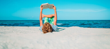 boy reading book at beach vacation, summer reading; Shutterstock ID 1808783944; client: 837; job: picturemaxx; other: susanne.finke@cornelsen.de; purchase_order: picturemaxx
boy reading book at beach vacation, summer reading