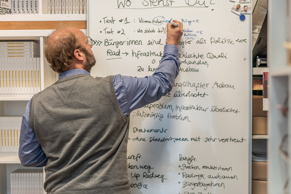 David Schraven schreibt an einem Whiteboard