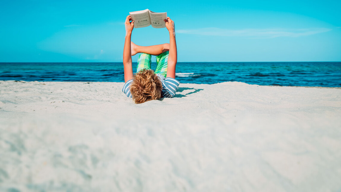 boy reading book at beach vacation, summer reading; Shutterstock ID 1808783944; client: 837; job: picturemaxx; other: susanne.finke@cornelsen.de; purchase_order: picturemaxx
boy reading book at beach vacation, summer reading